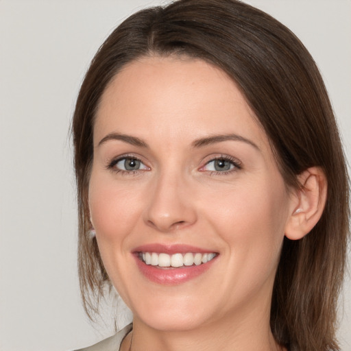 Joyful white young-adult female with medium  brown hair and brown eyes