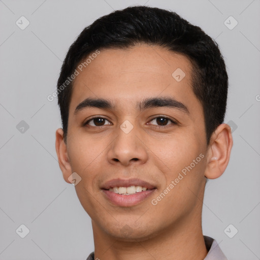 Joyful latino young-adult male with short  black hair and brown eyes