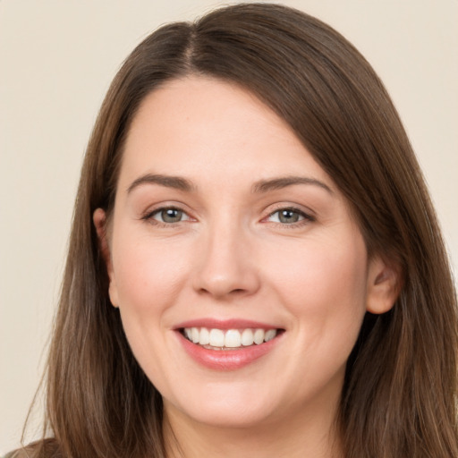 Joyful white young-adult female with long  brown hair and brown eyes