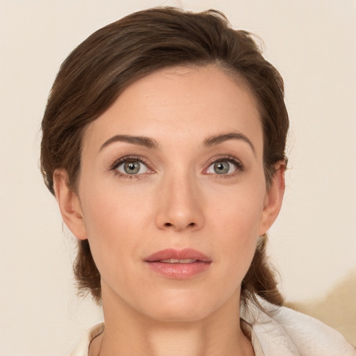 Joyful white young-adult female with medium  brown hair and grey eyes