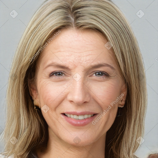 Joyful white adult female with long  brown hair and brown eyes