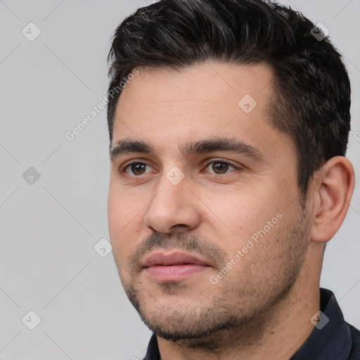 Joyful white young-adult male with short  black hair and brown eyes