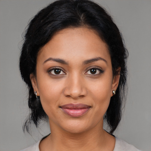 Joyful latino young-adult female with medium  black hair and brown eyes