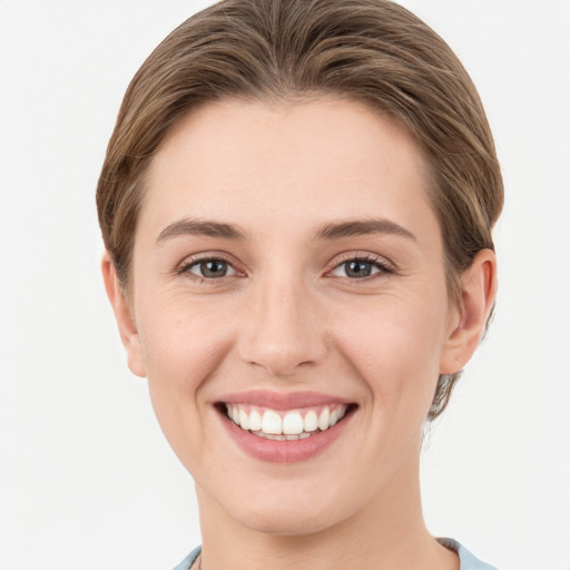 Joyful white young-adult female with short  brown hair and grey eyes