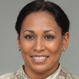 Joyful latino adult female with short  brown hair and brown eyes
