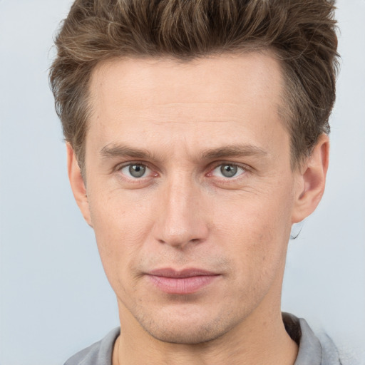 Joyful white adult male with short  brown hair and grey eyes