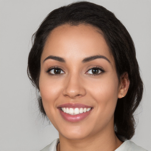 Joyful latino young-adult female with medium  black hair and brown eyes