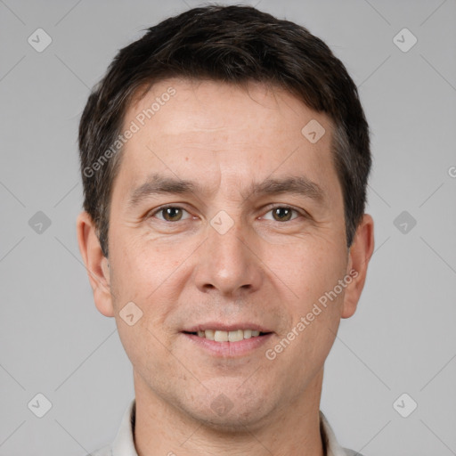 Joyful white adult male with short  brown hair and brown eyes