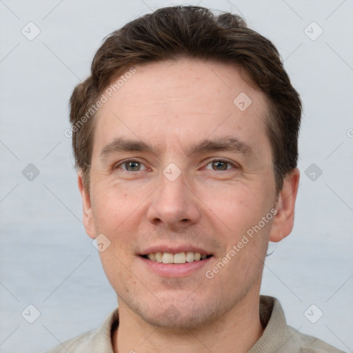 Joyful white adult male with short  brown hair and grey eyes