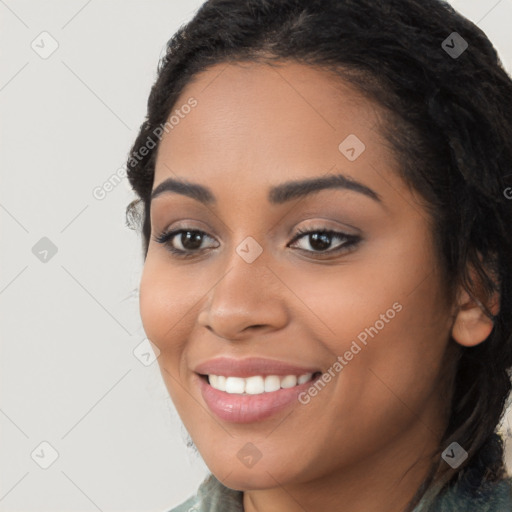 Joyful latino young-adult female with long  brown hair and brown eyes