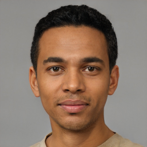 Joyful latino young-adult male with short  black hair and brown eyes