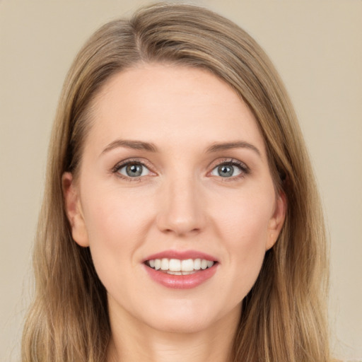 Joyful white young-adult female with long  brown hair and green eyes