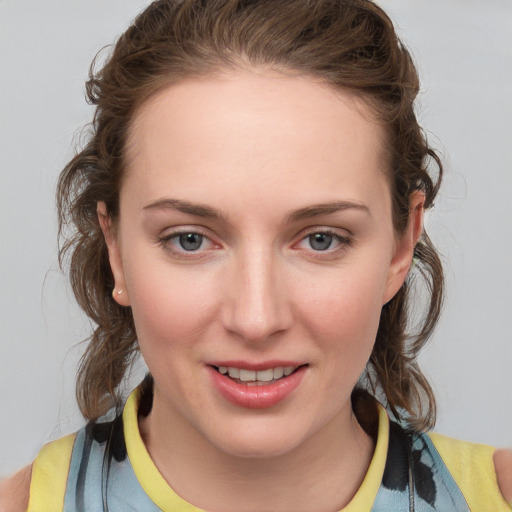 Joyful white young-adult female with medium  brown hair and blue eyes