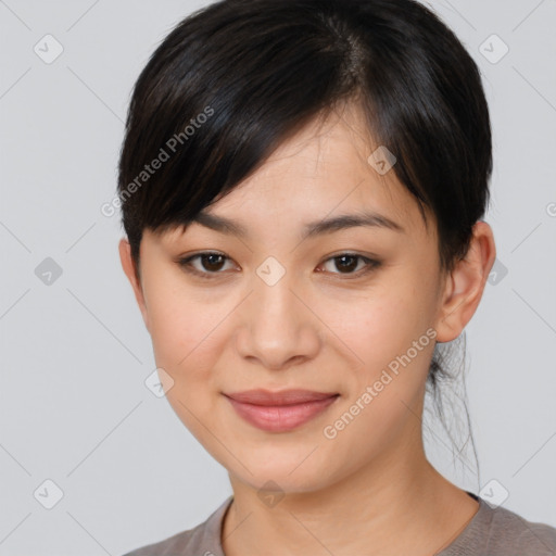 Joyful asian young-adult female with short  brown hair and brown eyes