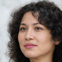 Joyful white adult female with long  brown hair and brown eyes