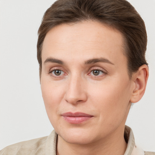 Joyful white young-adult female with short  brown hair and grey eyes