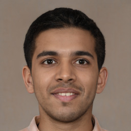 Joyful latino young-adult male with short  brown hair and brown eyes