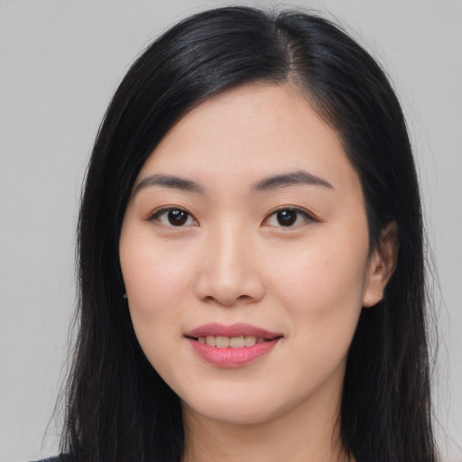 Joyful asian young-adult female with long  black hair and brown eyes