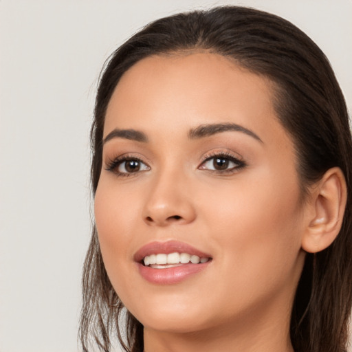 Joyful white young-adult female with long  black hair and brown eyes