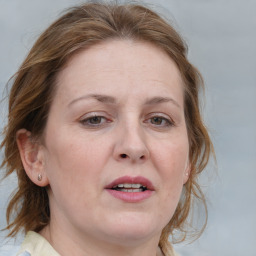 Joyful white adult female with medium  brown hair and blue eyes