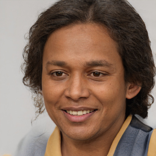 Joyful latino adult female with short  brown hair and brown eyes