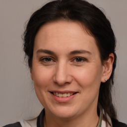 Joyful white adult female with medium  brown hair and brown eyes