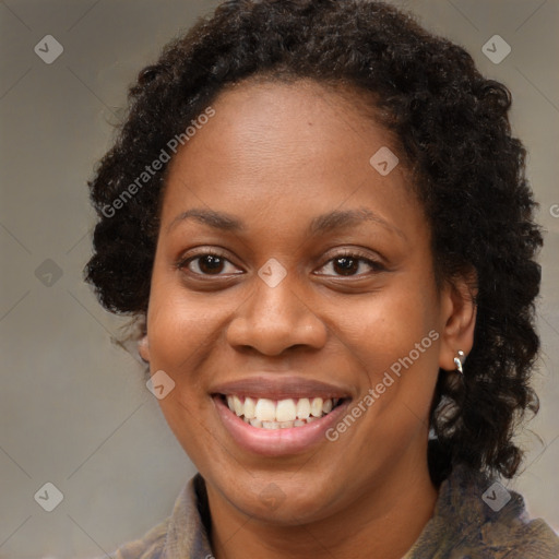 Joyful black young-adult female with long  brown hair and brown eyes