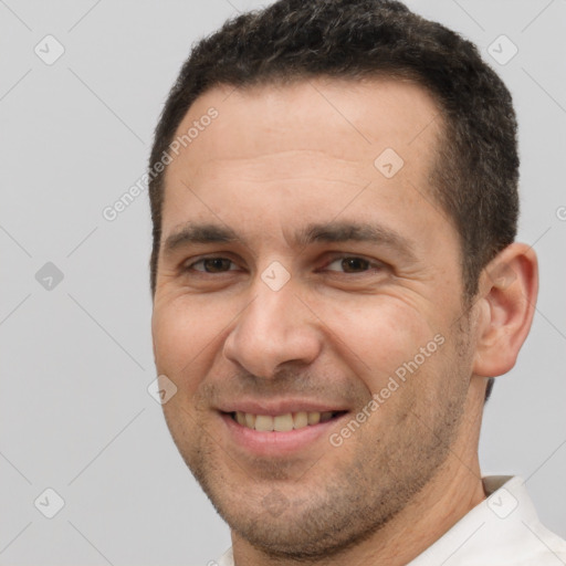 Joyful white adult male with short  brown hair and brown eyes