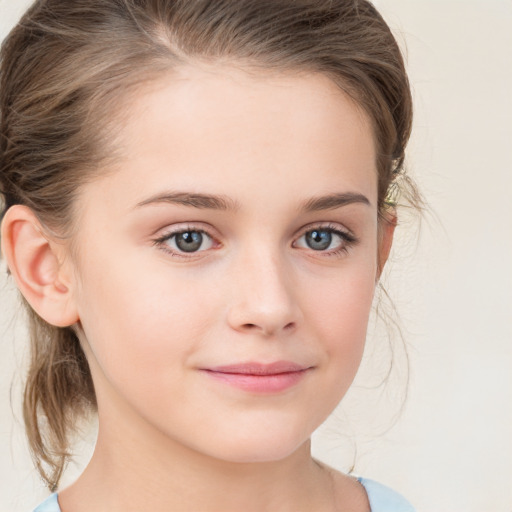 Joyful white child female with medium  brown hair and grey eyes