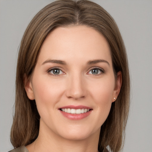 Joyful white young-adult female with medium  brown hair and grey eyes