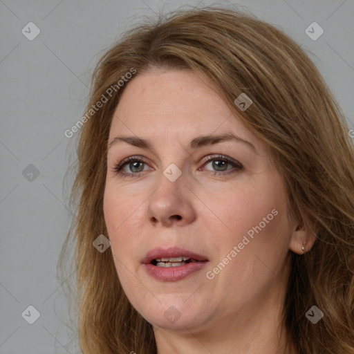 Joyful white adult female with medium  brown hair and brown eyes