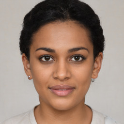 Joyful latino young-adult female with short  brown hair and brown eyes