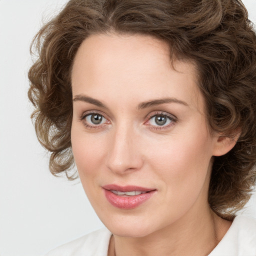 Joyful white young-adult female with medium  brown hair and green eyes