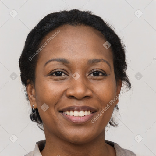 Joyful black adult female with medium  brown hair and brown eyes