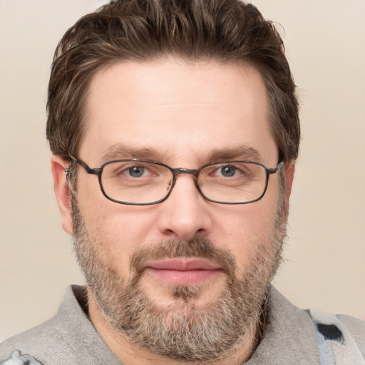 Joyful white adult male with short  brown hair and grey eyes