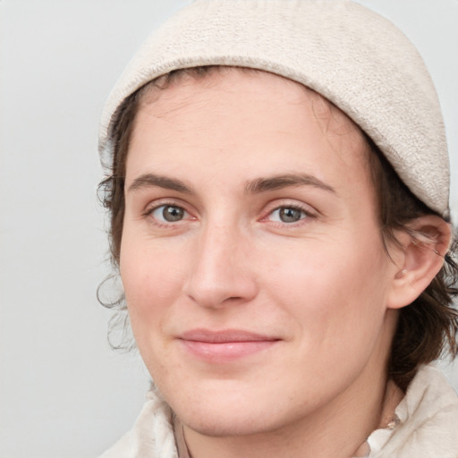 Joyful white young-adult female with medium  brown hair and blue eyes