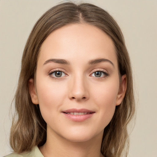 Joyful white young-adult female with long  brown hair and green eyes