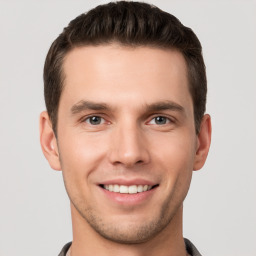 Joyful white young-adult male with short  brown hair and brown eyes