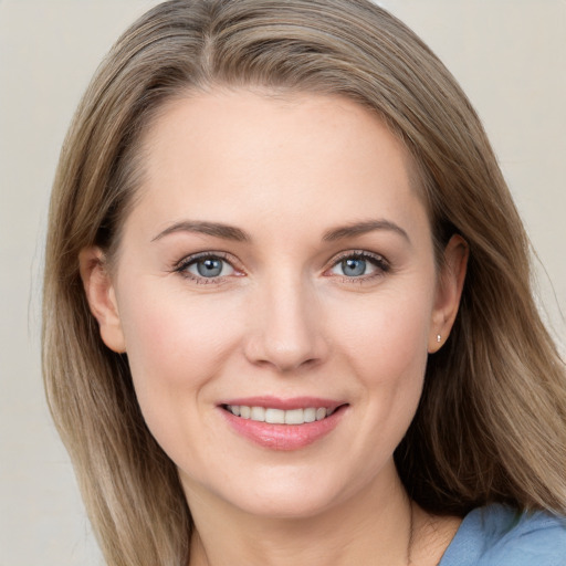 Joyful white young-adult female with long  brown hair and blue eyes