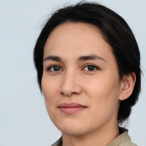 Joyful white young-adult female with medium  black hair and brown eyes