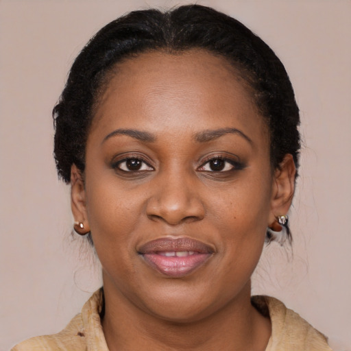 Joyful black adult female with medium  brown hair and brown eyes