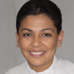Joyful latino young-adult female with short  brown hair and brown eyes