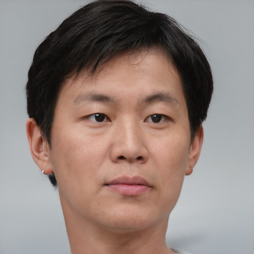 Neutral asian adult male with short  brown hair and brown eyes