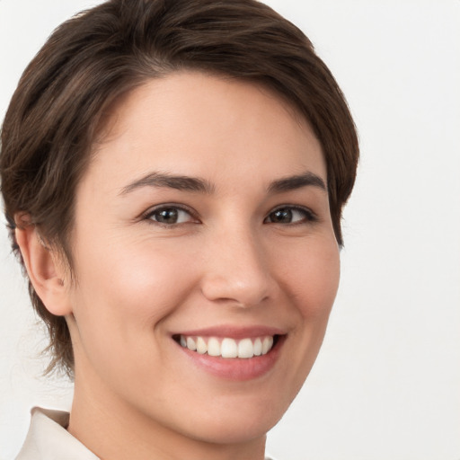 Joyful white young-adult female with short  brown hair and brown eyes