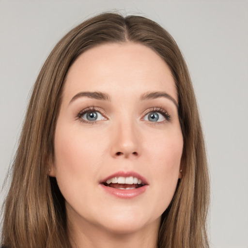 Joyful white young-adult female with long  brown hair and grey eyes