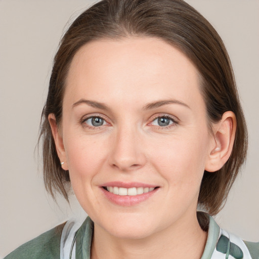 Joyful white young-adult female with medium  brown hair and grey eyes