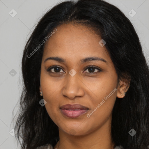 Joyful black young-adult female with long  brown hair and brown eyes