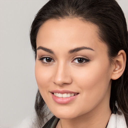 Joyful white young-adult female with long  brown hair and brown eyes