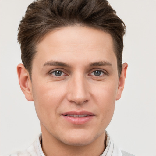 Joyful white young-adult male with short  brown hair and grey eyes