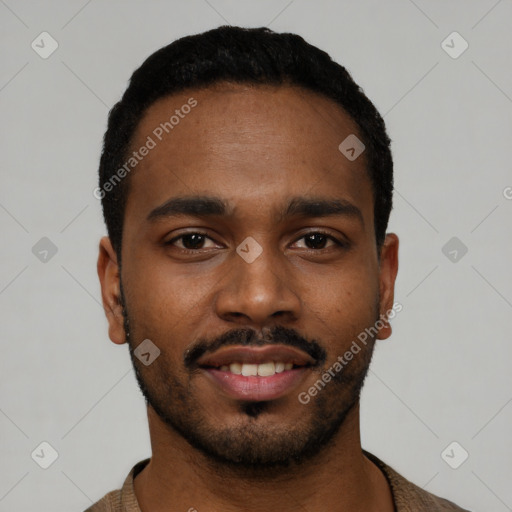 Joyful black young-adult male with short  black hair and brown eyes